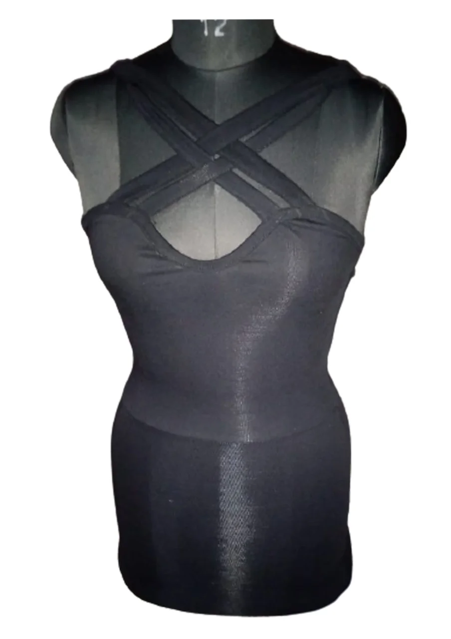 Black top with crisscross strap detail at neckline on a dress mannequin, plain background