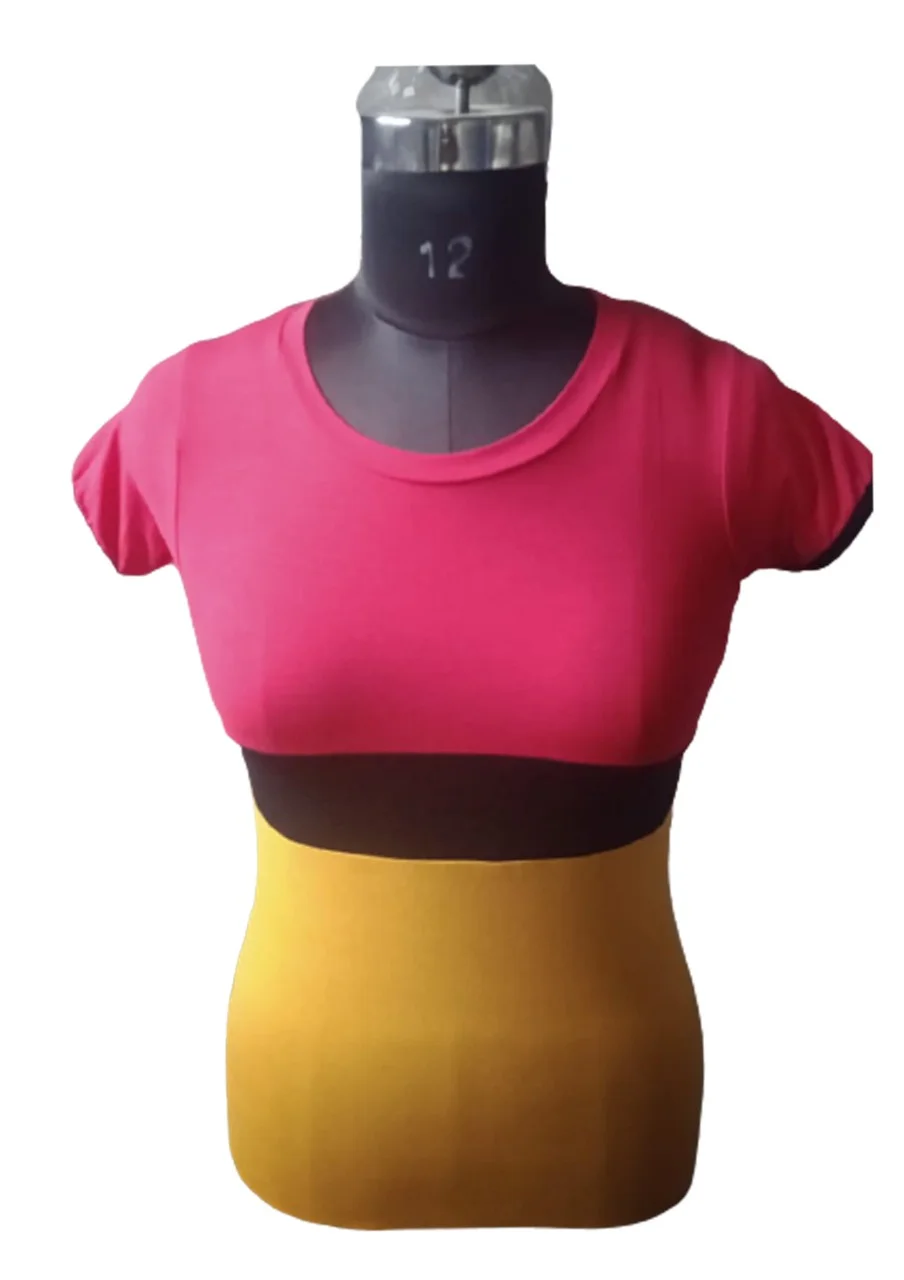 Pink and mustard yellow colorblock top on a dress mannequin, plain background